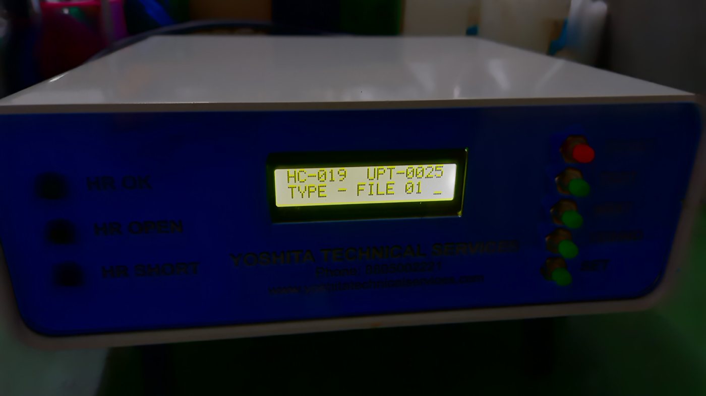 Yoshita harness tester front panel with LCD displaying a test program